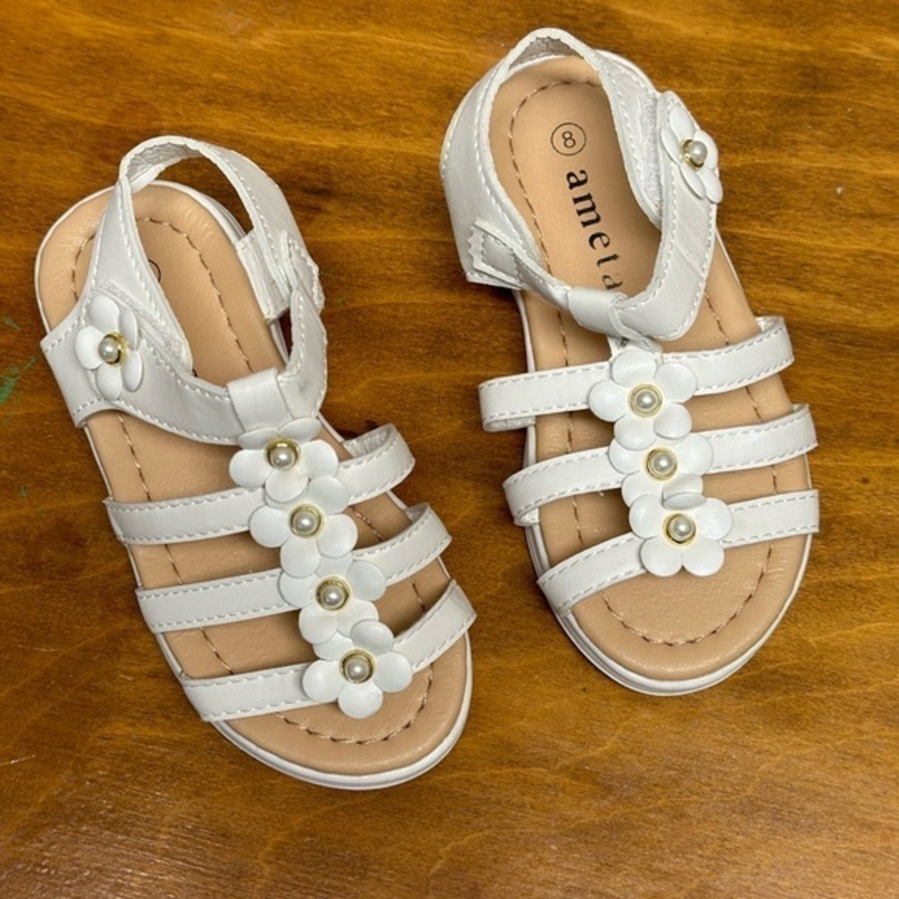 Ameta. Girls white sandals size 8  like new. Has pearls and flowers.